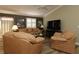 Inviting living room features neutral color palette, comfortable leather furniture and modern entertainment center at 2039 Thurmond Ave, The Villages, FL 32162