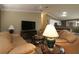 Inviting living room features neutral color palette, comfortable leather furniture and modern entertainment center at 2039 Thurmond Ave, The Villages, FL 32162