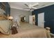Spacious main bedroom featuring a comfortable bed, ceiling fan, and private bathroom access at 2039 Thurmond Ave, The Villages, FL 32162