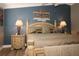 Comfortable main bedroom with ceiling fan and natural lighting with wooden furniture at 2039 Thurmond Ave, The Villages, FL 32162