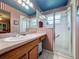 Bathroom with a glass enclosed shower, large mirror and vanity with sink at 2131 Burley Ave, Clermont, FL 34711