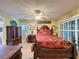 Bedroom features ornate wood furniture, plantation shutters and a ceiling fan at 2131 Burley Ave, Clermont, FL 34711