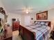 Traditional bedroom with a ceiling fan, dresser, and neutral decor at 2131 Burley Ave, Clermont, FL 34711