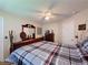 Comfortable bedroom with a ceiling fan and a traditional-style dresser with ornate mirror at 2131 Burley Ave, Clermont, FL 34711