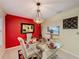 A modern dining room with a glass table, seating, and a stylish accent wall at 2131 Burley Ave, Clermont, FL 34711