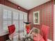 Bright dining area showcasing a glass table and chairs, enhanced by plantation shutters at 2131 Burley Ave, Clermont, FL 34711