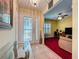 Inviting foyer with decorative glass door and a glimpse into the living room at 2131 Burley Ave, Clermont, FL 34711