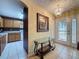 Foyer view into kitchen and dining area, highlighting tiled floors and ornate lighting at 2131 Burley Ave, Clermont, FL 34711