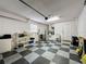 Bright garage with epoxy flooring, utility sink, and water heater at 2131 Burley Ave, Clermont, FL 34711