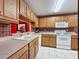 Functional kitchen with light wood cabinetry and a convenient pass-through to dining area at 2131 Burley Ave, Clermont, FL 34711