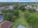 An aerial view shows a residential neighborhood with lush green spaces and mature trees in the yards at 22217 Caledonia Dr, Leesburg, FL 34748