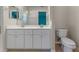 Well-lit bathroom features double sinks and a neutral color scheme at 22217 Caledonia Dr, Leesburg, FL 34748