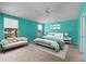 Bright bedroom featuring a white bed frame, neutral carpeting, and a comfortable seating area by the window at 22217 Caledonia Dr, Leesburg, FL 34748