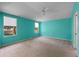 Bright bedroom boasts large windows and soft carpeting, creating a serene atmosphere at 22217 Caledonia Dr, Leesburg, FL 34748