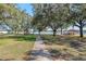 Picturesque lake view with community gazebos surrounded by mature trees and lush greenery at 22217 Caledonia Dr, Leesburg, FL 34748