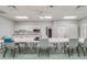 Bright community craft room featuring tables, chairs, and a convenient kitchenette at 22217 Caledonia Dr, Leesburg, FL 34748
