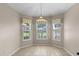 Cozy dining nook illuminated by a pendant light and three windows at 22217 Caledonia Dr, Leesburg, FL 34748