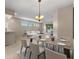Elegant dining area with modern lighting fixture and neutral tones to highlight the room's open floor plan at 22217 Caledonia Dr, Leesburg, FL 34748