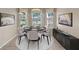 Cozy dining room featuring a round table with six chairs and elegant window decor at 22217 Caledonia Dr, Leesburg, FL 34748