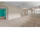 Spacious living room features neutral carpeting and an open floor plan at 22217 Caledonia Dr, Leesburg, FL 34748