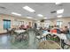 Spacious community meeting room with tables, chairs, and a whiteboard for resident use at 22217 Caledonia Dr, Leesburg, FL 34748