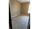 Neutral bedroom featuring tan walls, carpet floors, and a sunlit window at 2381 Missouri Ave, St Cloud, FL 34769