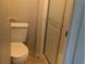 Bathroom featuring a toilet and glass enclosed tiled shower at 2871 Myakka River Rd, Tavares, FL 32778