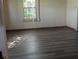 Bedroom featuring a neutral color scheme with dark wood laminate flooring at 2871 Myakka River Rd, Tavares, FL 32778
