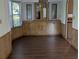 A dining room with wood laminate flooring, built-in cabinets and a bay window at 2871 Myakka River Rd, Tavares, FL 32778