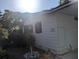 This cozy home features a landscaped yard and a well-maintained exterior with an outdoor storage area at 2871 Myakka River Rd, Tavares, FL 32778