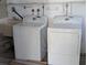 Bright laundry room featuring a washer, dryer, and utility sink at 2871 Myakka River Rd, Tavares, FL 32778