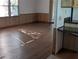 An open room featuring neutral colored laminate flooring and paneled walls at 2871 Myakka River Rd, Tavares, FL 32778