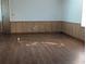 Bright living room featuring wood-look flooring and paneled walls with a calming natural light at 2871 Myakka River Rd, Tavares, FL 32778