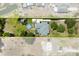 Aerial shot showcasing the home's layout, pool area, surrounding greenery and location at 28924 Discovery Rd, Tavares, FL 32778