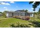 Backyard featuring a screened patio and lush green lawn at 28924 Discovery Rd, Tavares, FL 32778