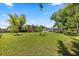 A sprawling backyard has mature shade trees, a red outbuilding, and pool at 28924 Discovery Rd, Tavares, FL 32778