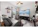 Bedroom with a tv, lounge chair, ship model, and coastal-themed decor at 28924 Discovery Rd, Tavares, FL 32778