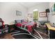 Bedroom featuring a cozy bed, keyboard, and a dedicated gaming chair at 28924 Discovery Rd, Tavares, FL 32778