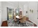 Dining room features a modern chandelier, large windows, and decorative furnishings at 28924 Discovery Rd, Tavares, FL 32778