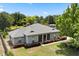 Aerial view of house with mature trees and landscaping, showcasing its curb appeal and setting at 28924 Discovery Rd, Tavares, FL 32778