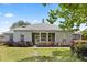 Charming single story home featuring a neutral exterior, arched windows and manicured landscaping on a lush lawn at 28924 Discovery Rd, Tavares, FL 32778