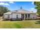 Charming single-story home with well-maintained landscaping and a welcoming front porch with classic columns at 28924 Discovery Rd, Tavares, FL 32778