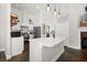 Bright kitchen featuring an island with quartz countertop, stainless steel appliances, and pendant lighting at 28924 Discovery Rd, Tavares, FL 32778