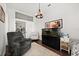 Bright room with an aquarium, chair, white cabinet, and a peek into the kitchen at 28924 Discovery Rd, Tavares, FL 32778