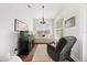 Bright room with a daybed, modern lighting, aquarium, and comfortable grey recliner chair at 28924 Discovery Rd, Tavares, FL 32778