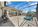 Covered and screened patio with an outdoor kitchen and relaxing lounge area at 28924 Discovery Rd, Tavares, FL 32778