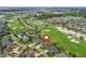 Beautiful aerial view of a home on a golf course community with nearby amenities at 2954 Cedar Grove Loop, The Villages, FL 32163