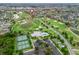 Beautiful aerial view of a golf course community featuring tennis courts, a pool, and pristine landscaping at 2954 Cedar Grove Loop, The Villages, FL 32163