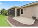 Backyard with patio that offers access to the screened-in patio at 2954 Cedar Grove Loop, The Villages, FL 32163