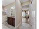 Bathroom leading to the living room features a granite vanity and a tiled walk-in shower at 2954 Cedar Grove Loop, The Villages, FL 32163